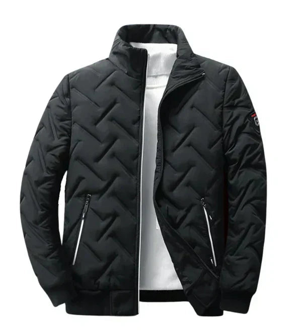 Black puffer jacket with chevron quilting, zip front, and two zip pockets.