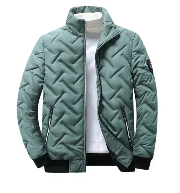 Teal puffer jacket with chevron quilting, zip front, and two zip side pockets.