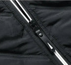 Close-up of black puffer jacket zipper and stitched quilting channels on the front.