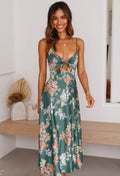 Green floral maxi dress with thin straps and front bow detail, sleeveless flowing fit