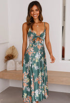 Green floral maxi dress with thin straps and front bow detail, sleeveless flowing fit