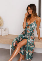 Green floral sleeveless maxi dress, thin straps with tied bow front, side view