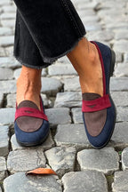 Women's navy slip-on loafers with red accent strap, rounded toe