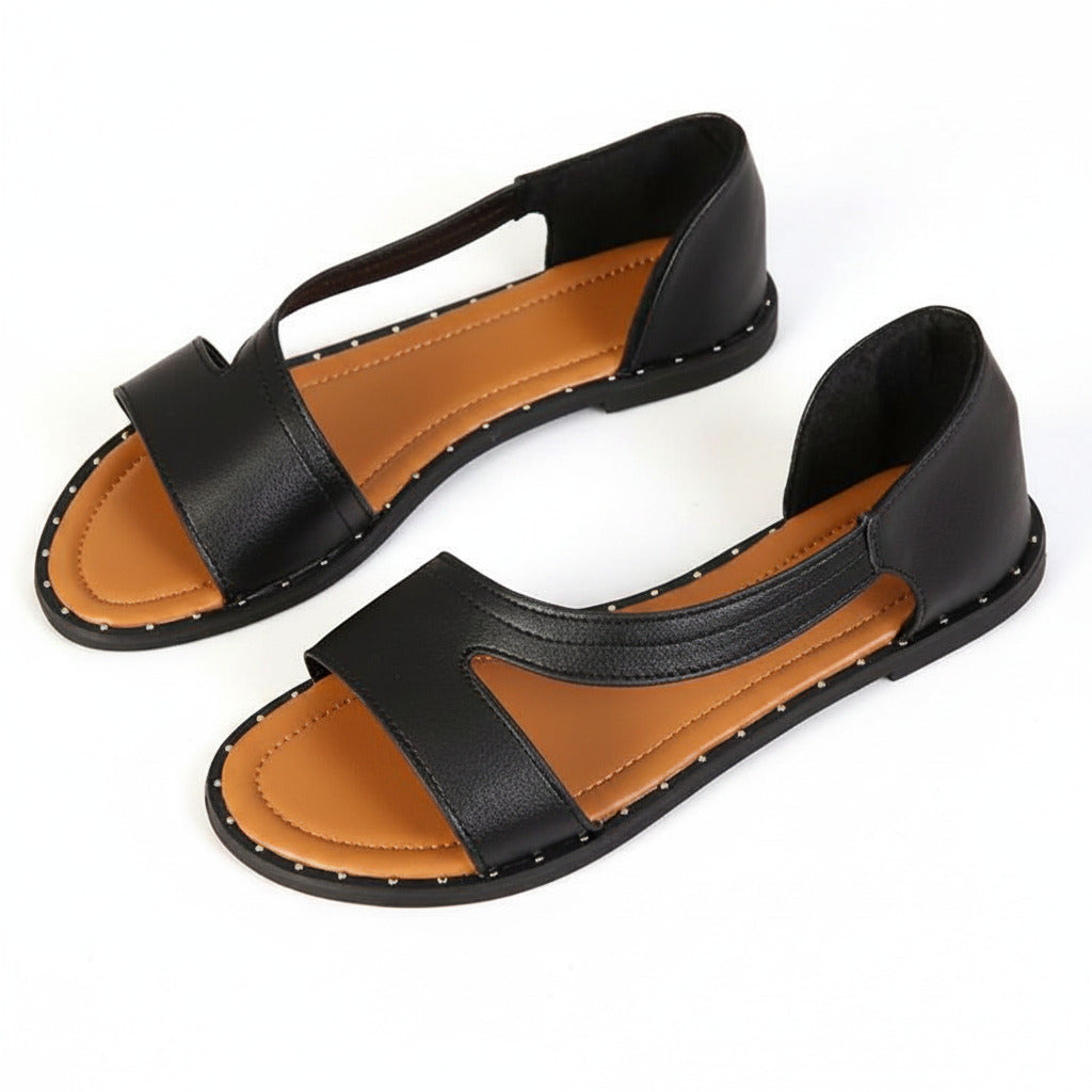 Black wide-fit flat sandals with open asymmetric upper and tan-lined footbed