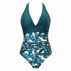 Teal halter one-piece swimsuit with ruched waist and tropical leaf print