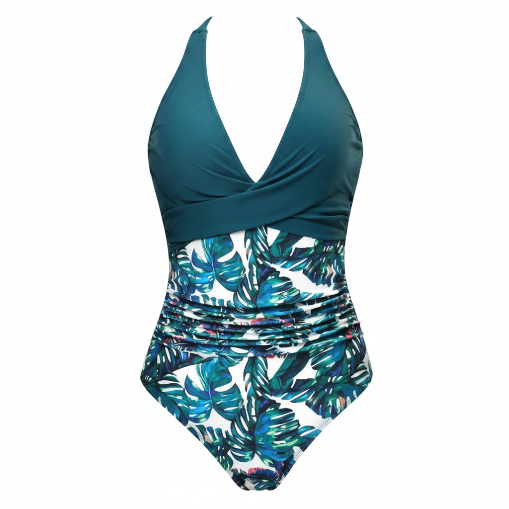 Teal halter one-piece swimsuit with ruched waist and tropical leaf print
