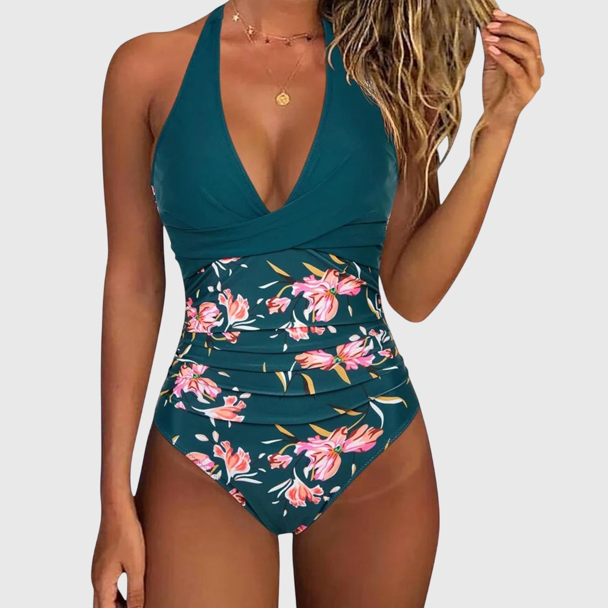 Teal halter one-piece swimsuit with ruched waist and pink floral leaf print