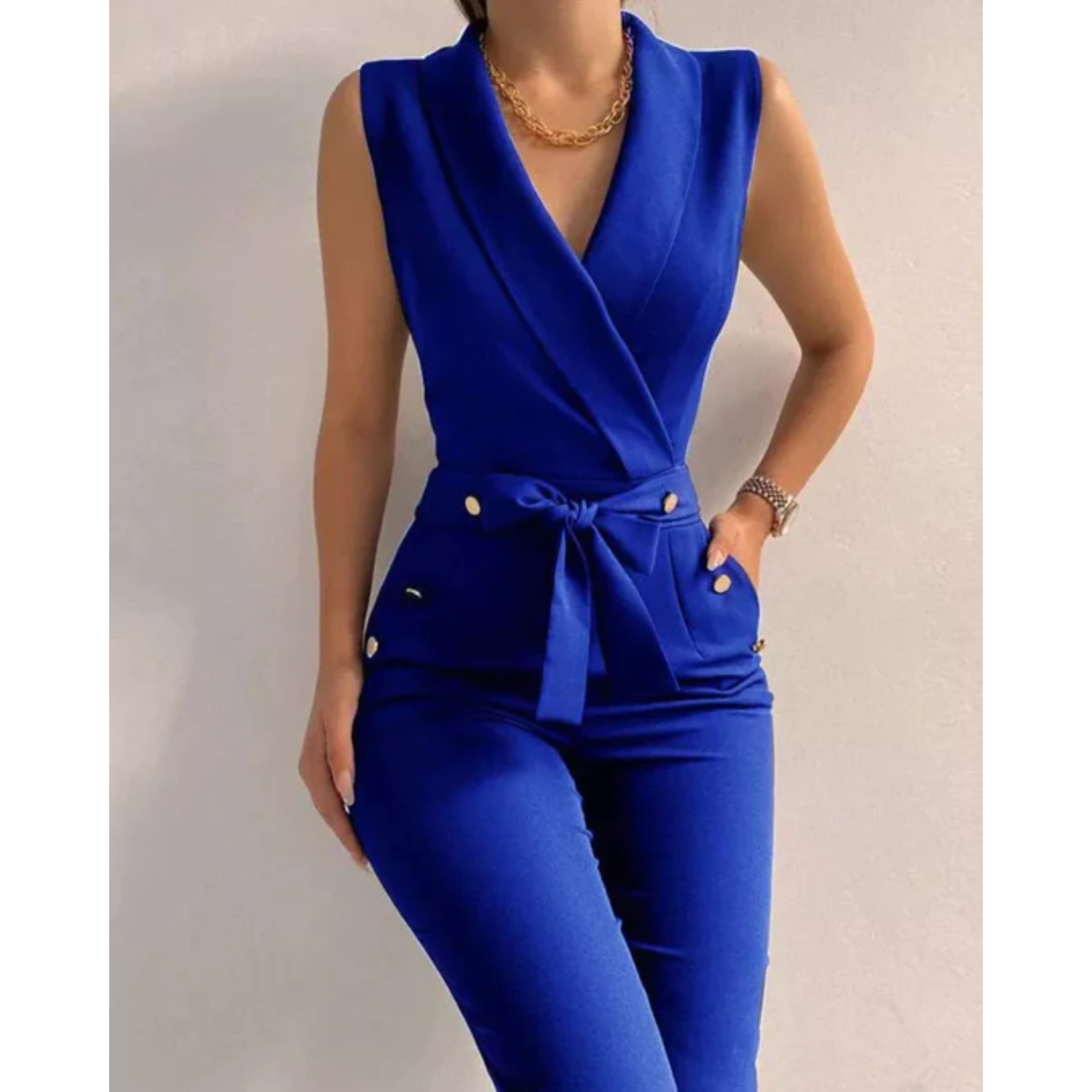 Women's blue sleeveless wrap jumpsuit, tied waist, decorative button pocket details
