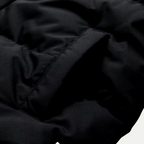 Close-up of black padded parka fabric with seam stitching and quilt panel