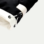 Black parka cuff with white fabric and drawcord eyelets, elastic sleeve hem