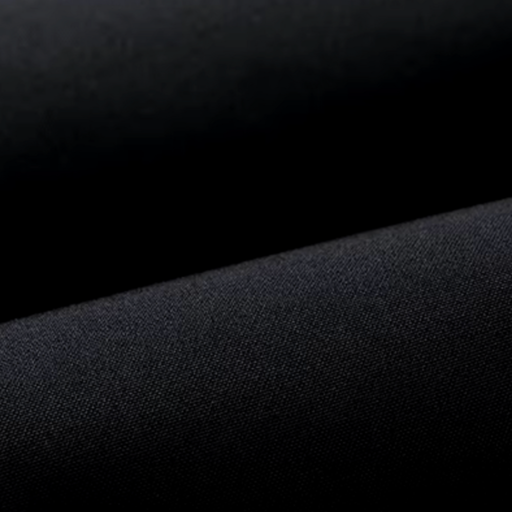 Close-up of dark textured parka fabric with fine woven pattern