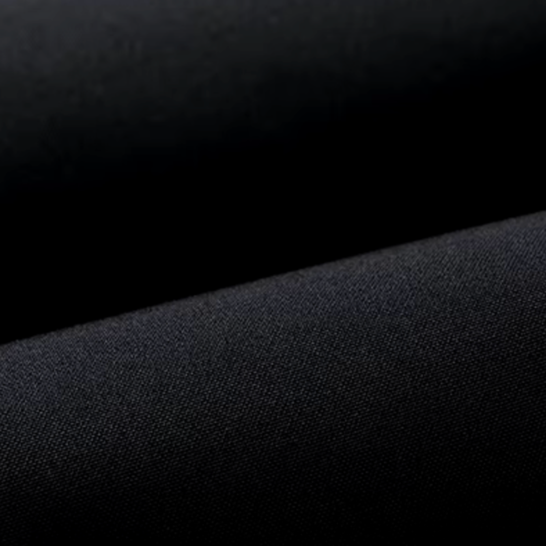 Close-up of dark textured parka fabric with fine woven pattern