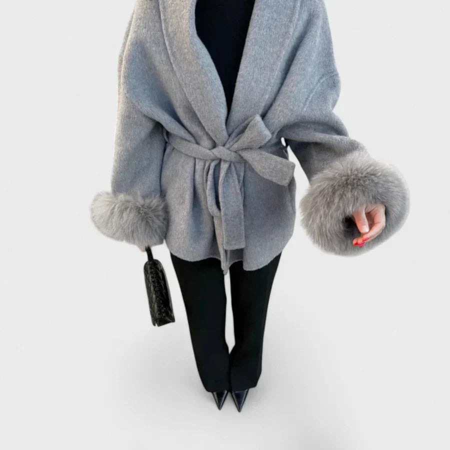 Gray coat with tied waist, V-neck styling, and faux fur cuff trim
