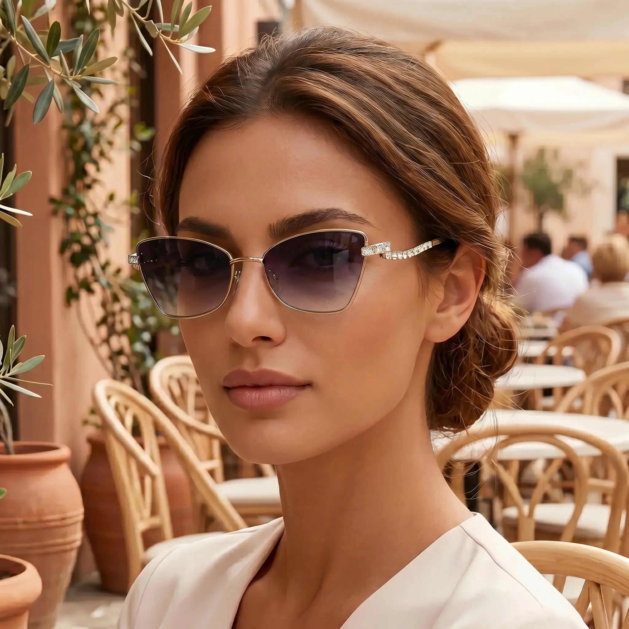 Cat-eye sunglasses in angled view with gold-tone metal frame and dark lenses