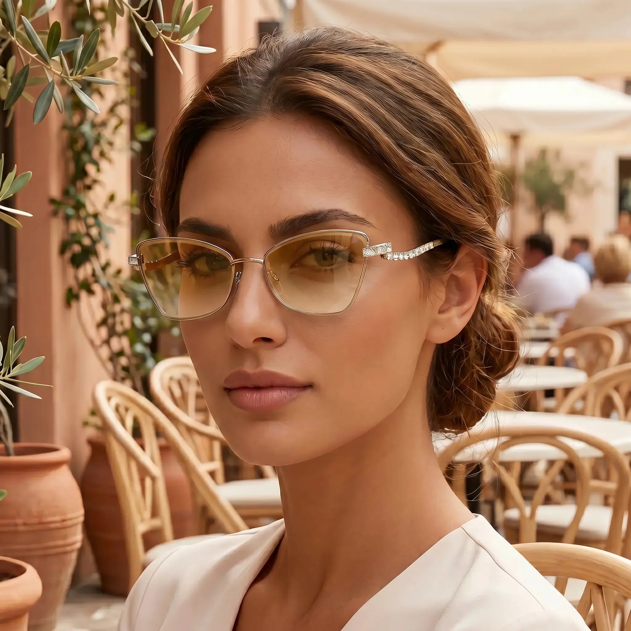 Cat-eye sunglasses with gold-tone metal frame and rhinestone bar detail on temple