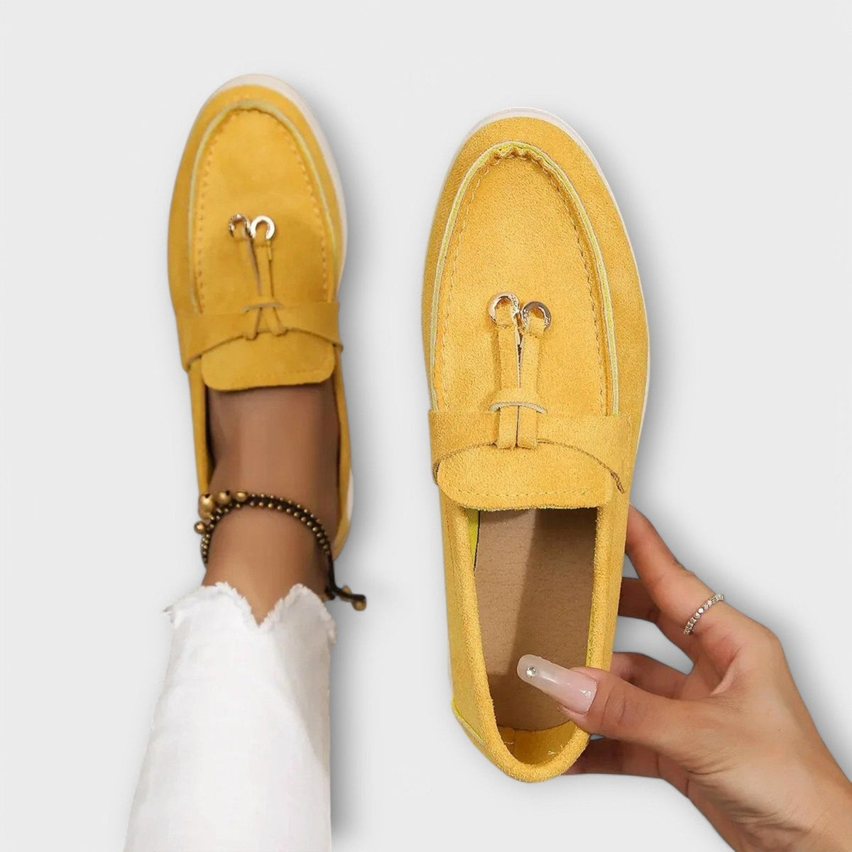 Women's yellow suede slip-on loafers with bowknot detail and metal loops