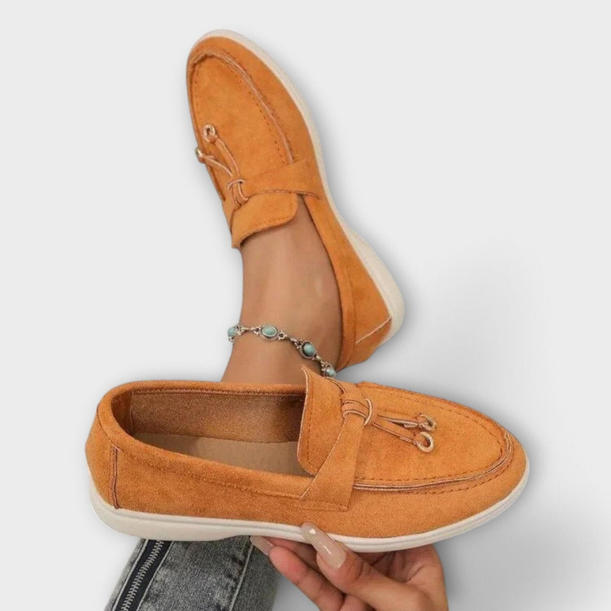 Women's orange suede slip-on loafers with bowknot vamp detail and metal loops