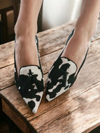 Women's pointed animal-print tassel loafers, black with white cow spots and green tassels