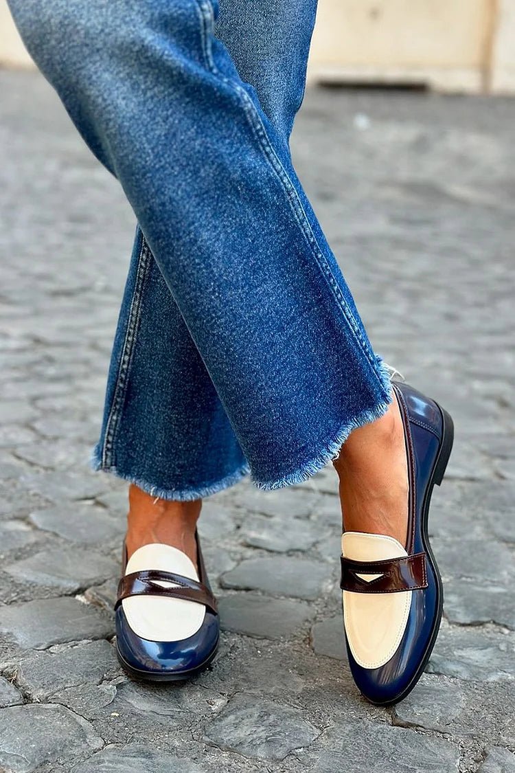 Two-tone leather slip-on loafers with navy and cream panels and strap detail