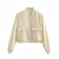 Light cream cropped bomber jacket with snap-button front and two flap chest pockets