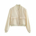 Light cream cropped bomber jacket with snap-button front and two flap chest pockets