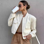 Light cream cropped bomber jacket with snap-button front, ribbed cuffs, and chest pockets