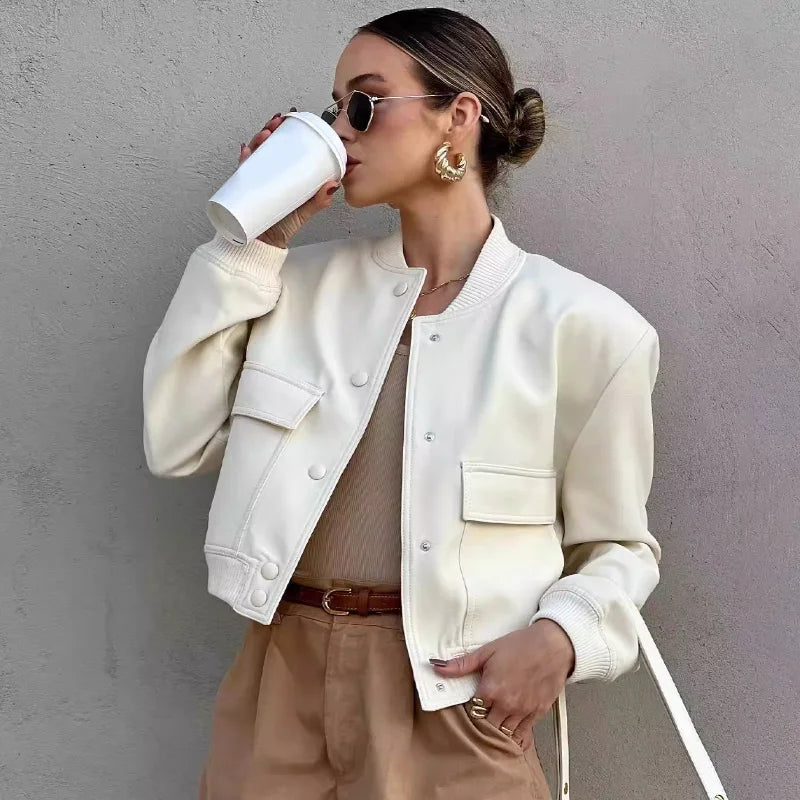 Light cream cropped bomber jacket with snap-button front, ribbed cuffs, and chest pockets