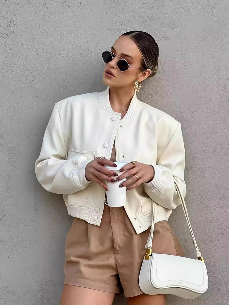 Light cream cropped bomber jacket with snap-button front, ribbed stand collar, and chest pockets