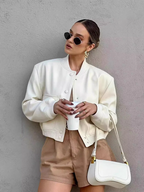 Light cream cropped bomber jacket with snap-button front, ribbed stand collar, and chest pockets