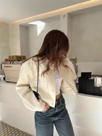 Light cream cropped bomber jacket back view with ribbed hem and cuffs