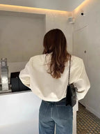 Light cream cropped bomber jacket back view with ribbed hem and cuffs