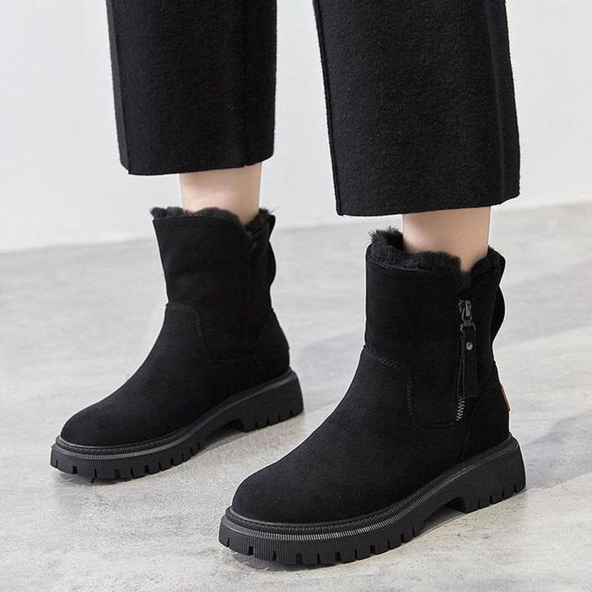 Black winter boots with plush lining, side zipper, and grippy tread sole