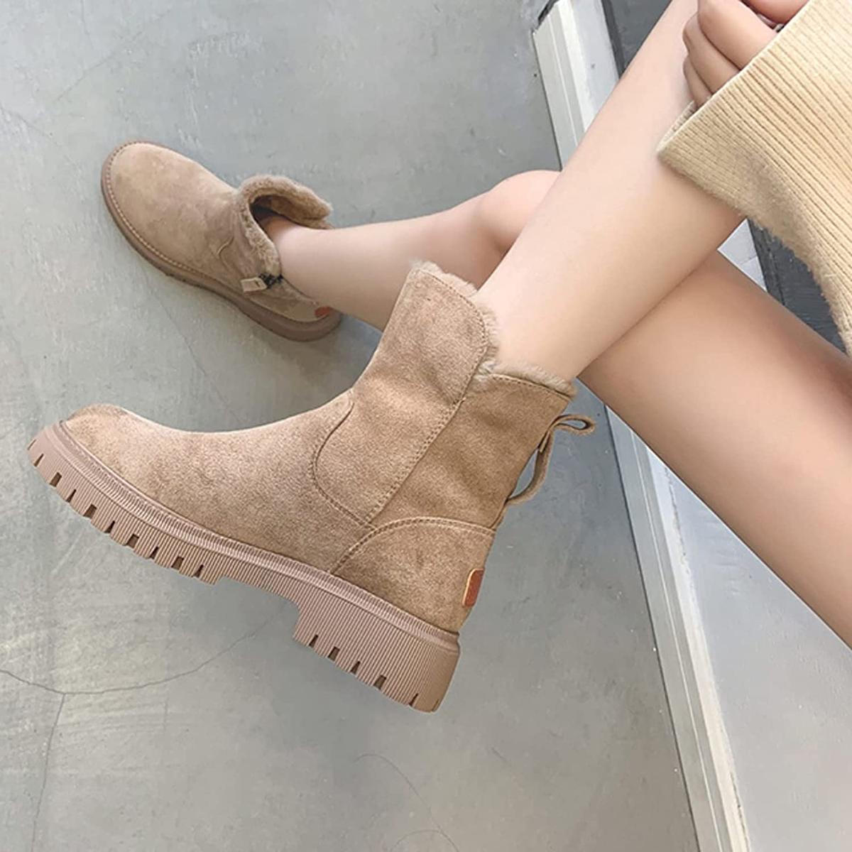 Beige winter boots with plush collar, side zipper, and tread sole