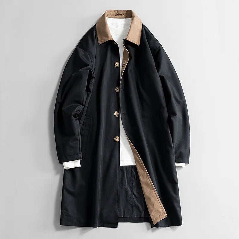 Black long coat with tan collar, button front, and side welt pockets