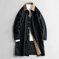 Black long coat with tan collar, button front, and side welt pockets