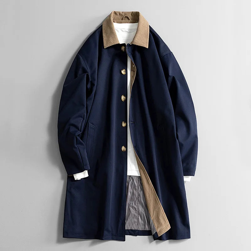 Navy long coat with tan collar, button front, and side welt pockets