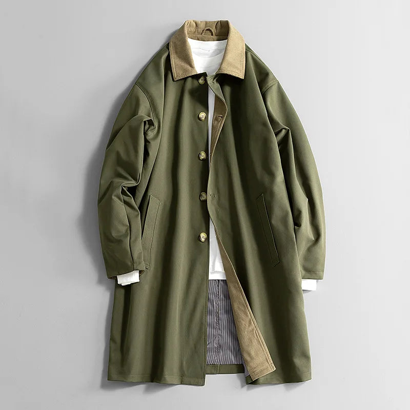 Olive green long coat with tan collar, button front, and side welt pockets