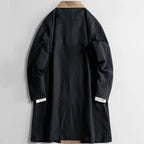 Black long coat back view with tan collar and long sleeves