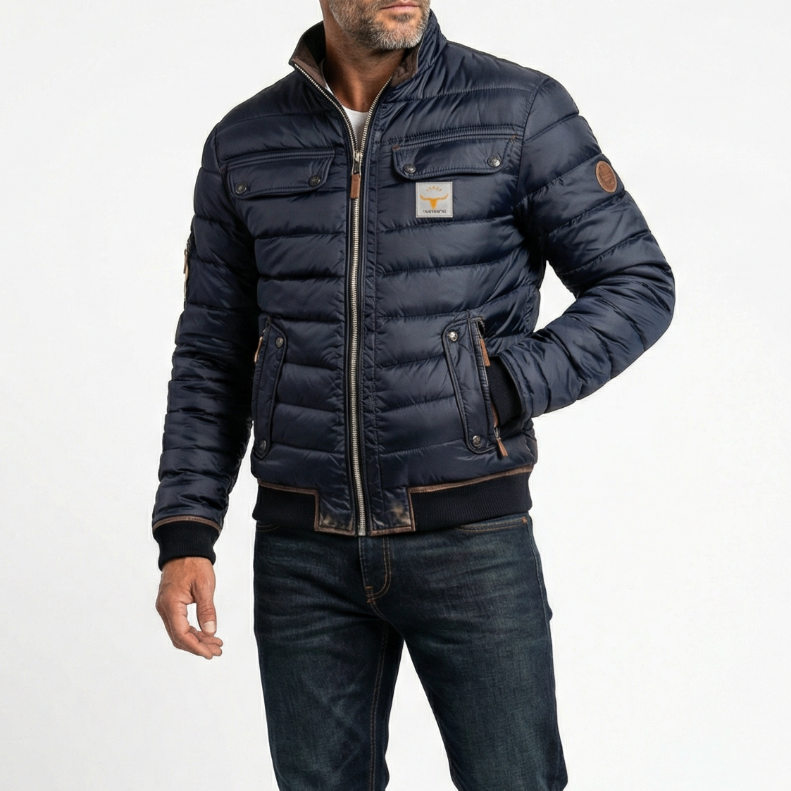 Men's navy quilted jacket with zip front, snap pockets, and circular sleeve patch