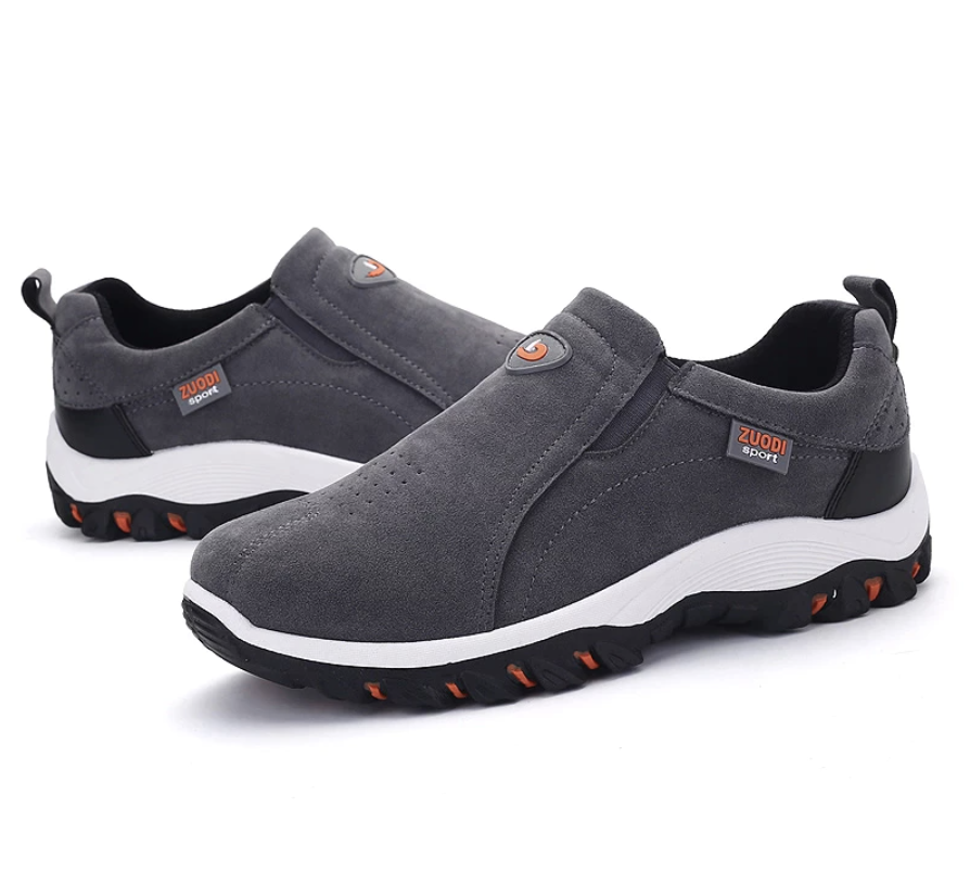 Men's dark gray slip-on hiking shoes with padded collar, white sole, and orange tread