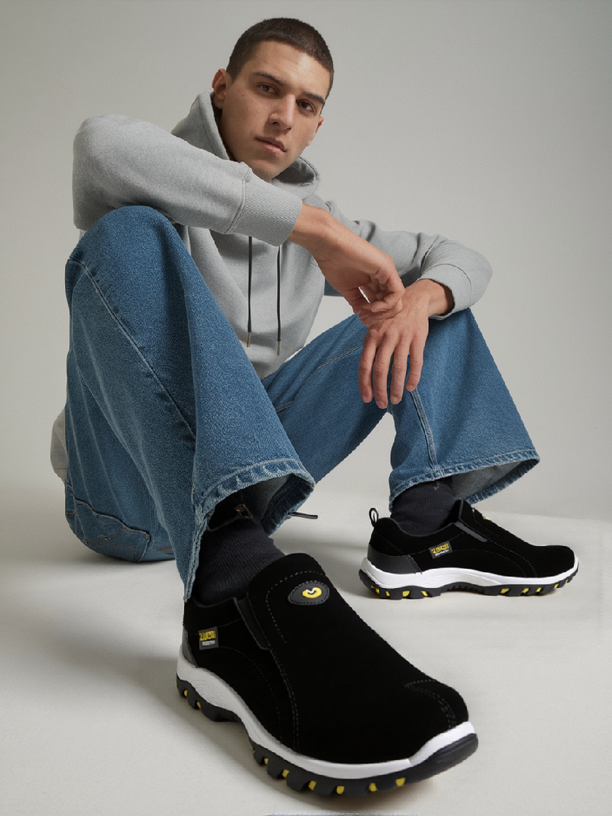 Men's black hiking shoes with low-profile slip-on design and white sole with orange tread