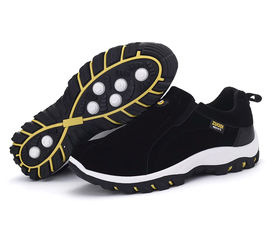 Men's black hiking shoe pair showing rugged outsole with yellow edge detail and grip lugs