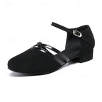 Black dance heels with ankle strap buckle, T-strap across the toes, block heel