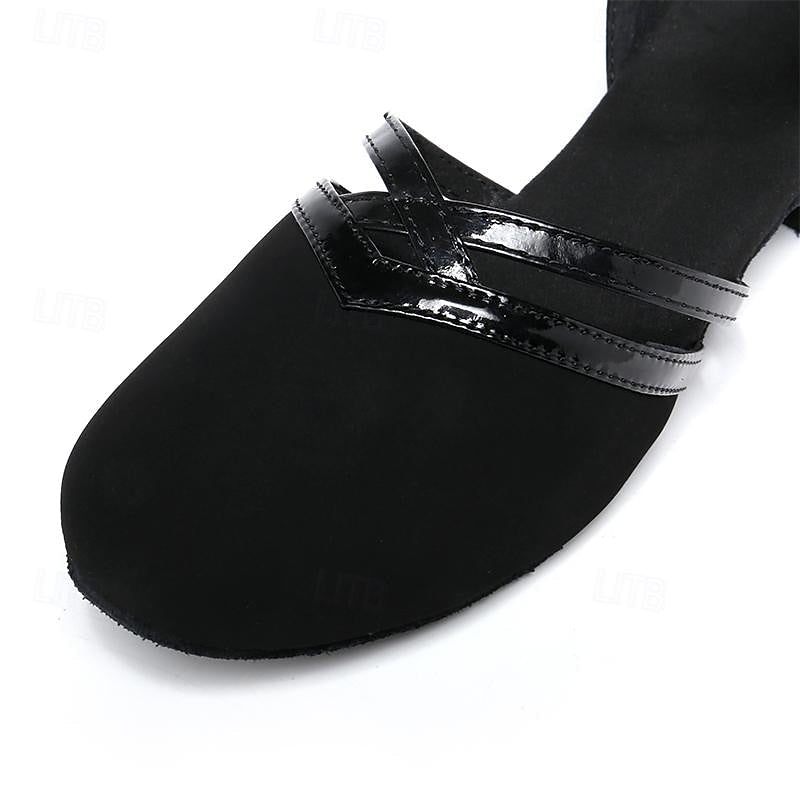 Black dance heel close-up: toe cap with glossy strap and stitch detail
