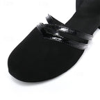 Black dance heel close-up: toe cap with glossy strap and stitch detail