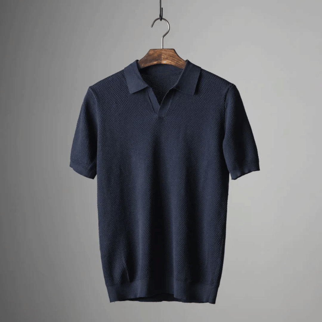 Navy blue men's knitted polo shirt hanging, short sleeves and buttoned collar