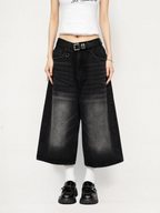 Black high-waisted wide-leg denim culottes with wide legs, pockets, and belt loops