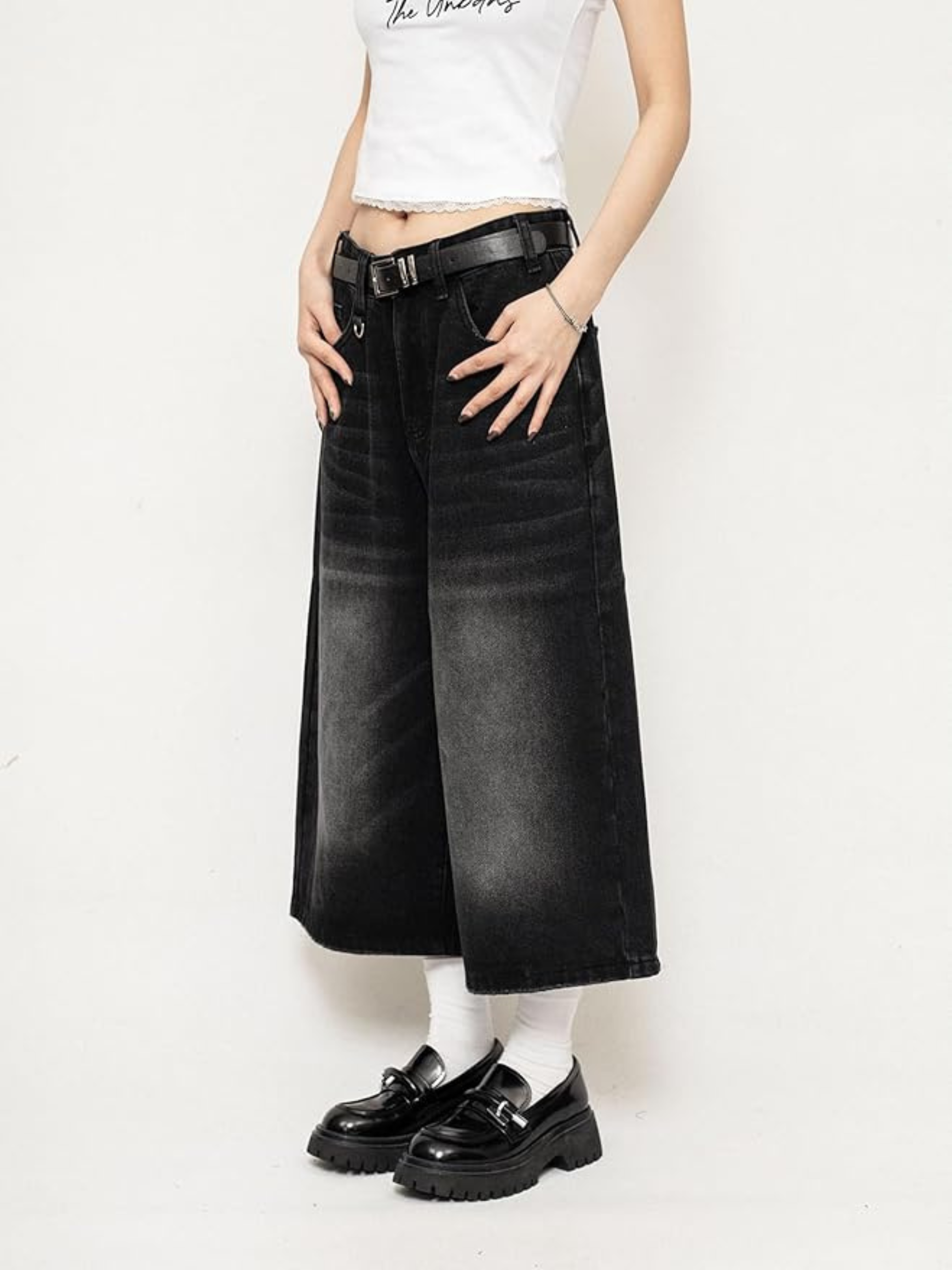Black high-waisted wide-leg denim culottes with leather belt and side pockets
