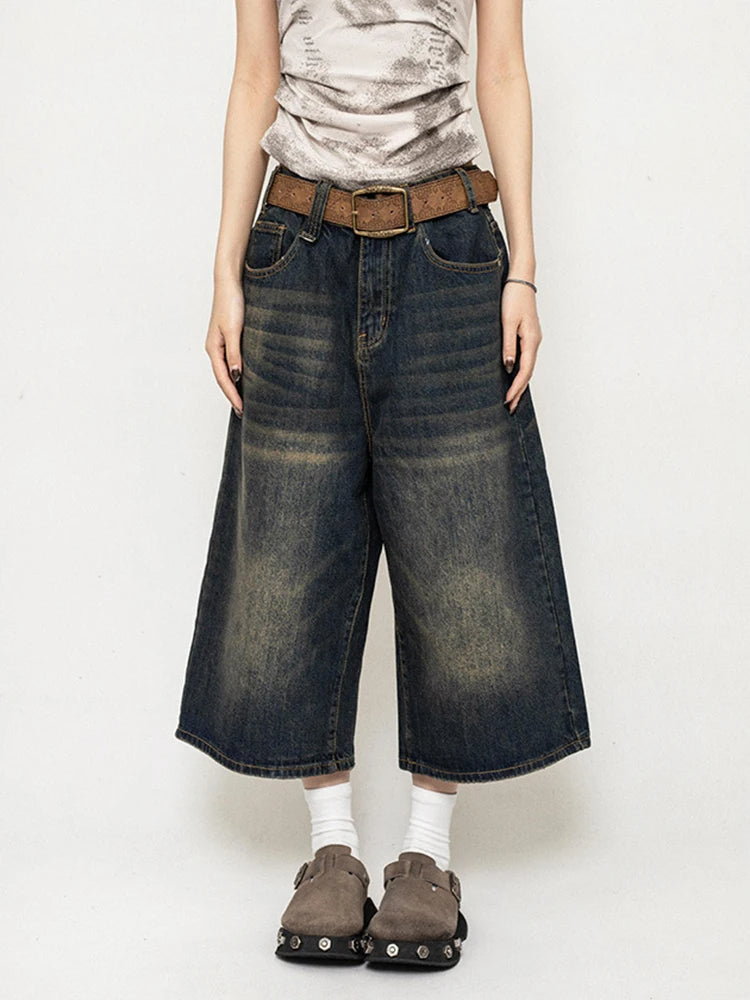 Dark blue high-waisted wide-leg denim culottes with belt loops and wide cuffs