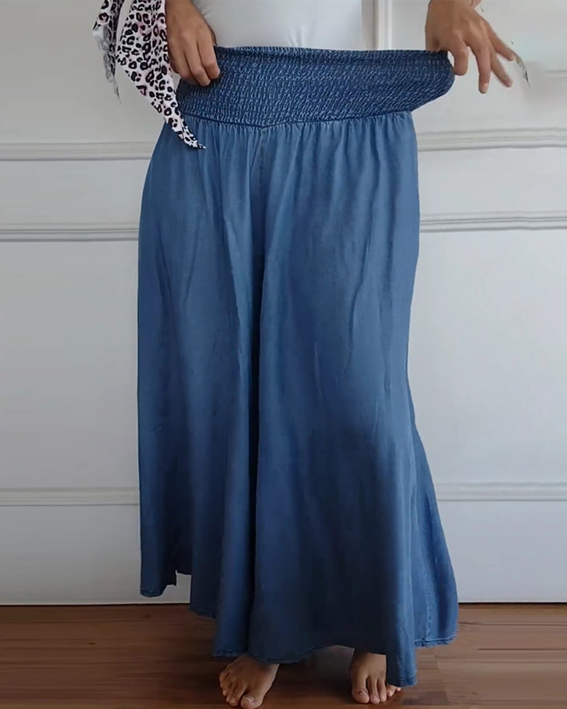 High-waisted wide-leg trousers with smocked elastic waistband, denim blue.